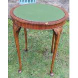 A circular Edwardian games table, with hinged revolving top, raised on four turned legs, diameter
