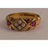 A 15 carat gold seed pearl and ruby ring, the four pearls set in a diamond shape with a ruby to each