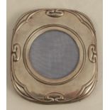 A hallmarked silver mounted photograph frame, embossed with Art Nouveau motifs, with wooden back and