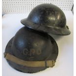 Two WW2 black painted helmets, one stamped "GPO"