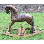A carved and painted wood rocking horse, on curved base, overall height 23ins, width 33ins.Condition