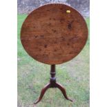 A 19th century oak snap top tripod table, diameter 21.5ins x height 26.5ins