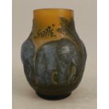 A Galle Tip glass vase, decorated with blue elephants and palm trees to an amber ground, height 4.