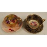 A Royal Worcester cup and saucer, decorated with flowers by Philips to an ornate gilt border,