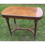 A Victorian walnut centre table, having central inlay to an ebonised border, raised on four plain