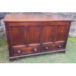 An 18th century oak mule chest, having four carved panels to the front and a plain rising lid,