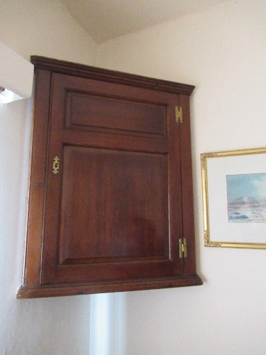 An 18th century oak corner cupboard, width 27ins