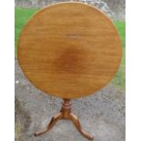 An antique mahogany circular tilt top table, raised on a turned column to a triform base, diameter