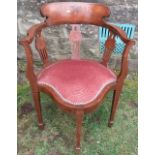 An Edwardian mahogany and inlaid corner chair, decorated with birds, flowers and scrolls, to  shaped