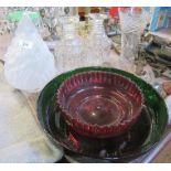 A collection of glassware, including shallow green bowl, decanters, glass lampshade stylised as a