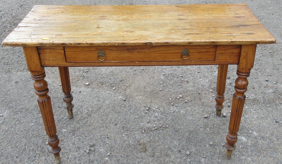 An antique pine side table, fitted with a frieze drawer and raised on turned legs, 43ins x 17.5ins x