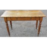 An antique pine side table, fitted with a frieze drawer and raised on turned legs, 43ins x 17.5ins x