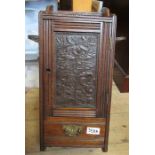 An Edwardian mahogany smokers wall cabinet, with carved decoration to the door and pipe racks either