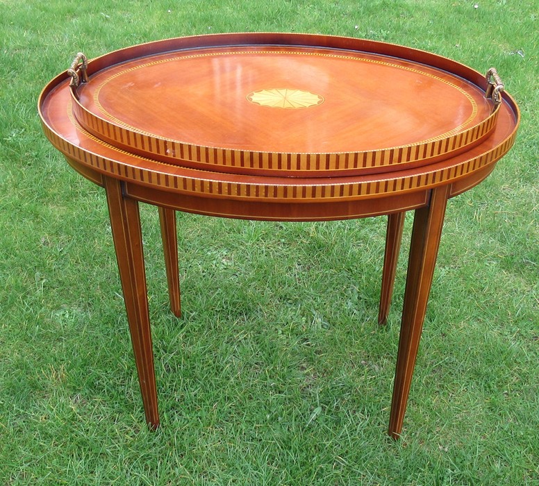 A mahogany and satinwood inlay oval table, the top with galleried sides, raised on square tapering