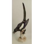 A continental porcelain model, of a magpie, astride a tree stump, damage to the tail, cross swords