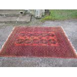 An Eastern design rug, with a burnt orange ground decorated with geometric patterns, 66ins x 93ins