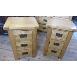 A pair of modern oak bedside cabinets, fitted with three drawers, 16ins x 18is x height 27.5ins