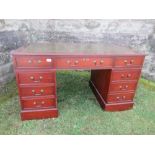 A reproduction pedestal desk, having leather writing surface, and drawers around the knee hole,