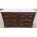 A 19th century oak dresser base, fitted with two banks of three drawers, with brass swan neck
