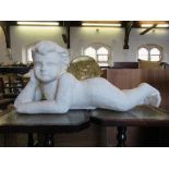 A plaster model of a recumbent putti, width 24ins