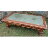 A mahogany low coffee table, with leather inset top, the carved frieze with drawers raised on carved