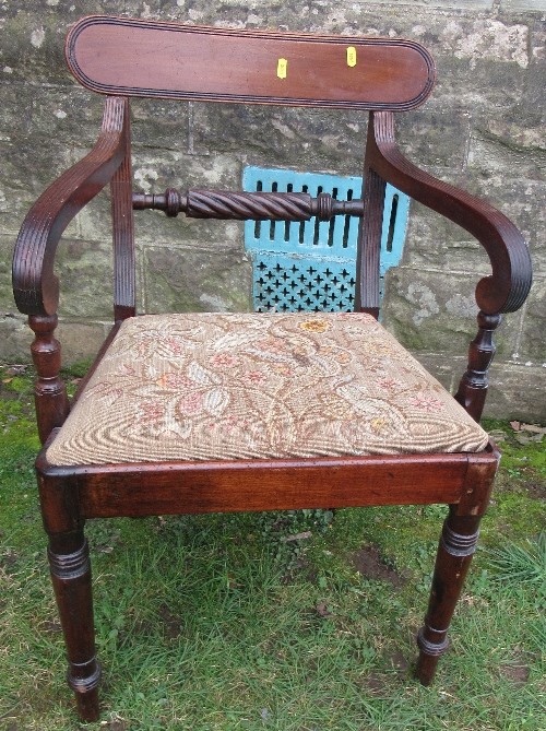 A 19th century mahogany Regency style open arm dining chair