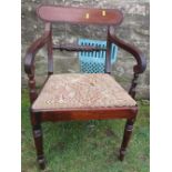 A 19th century mahogany Regency style open arm dining chair
