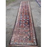 A long Eastern design runner, decorated to a blue ground with medallions, length 140ins x width