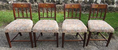 A set of four 19th century mahogany dining chairs, with stuff over seats