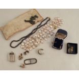 A collection of various jewellery items, including freshwater cultured pearls, a buckle, and a small