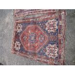 Two similar Eastern design rugs, both with a red ground , decorated with stylised geometric patterns