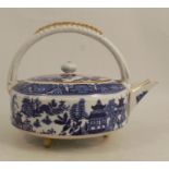 A Royal Worcester tea pot, printed with a blue and white willow pattern, with fixed wicker moulded