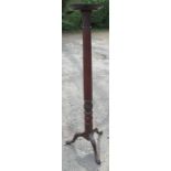 A mahogany torchere, with carved column, raised on three outswept supports, height 60ins