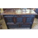 An antique oak mule chest, with rising lid, the front carved with flowers and leaves, fitted with