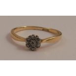 An 18 carat gold seven stone diamond cluster ring, the central diamond, diameter 2mm, set around