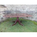 A 19th century mahogany tilt top breakfast table, the rectangular top raised on a turned column