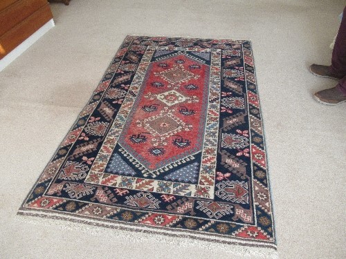 An Eastern style rug, having red medallions, and three lozenge motifs to a blue border, 80ins x - Image 3 of 3