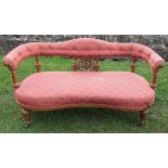 A Victorian show wood settee, with upholstered shaped top rail, having carved and turned supports to