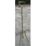 A brass telescopic oil lamp stand, with leaf and flower decoration, raised on a triform base,