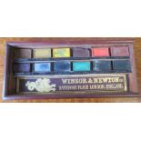 A Winsor & Newton mahogany artist paint box, containing paint, with sliding lid, 7ins x 3ins, height