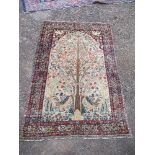 An Eastern style rectangular rug, decorated to a central beige field with a tree of life, 78ins x