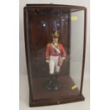 A porcelain model of a soldier, in glass caseCondition Report: Stuck in the case but appears to be