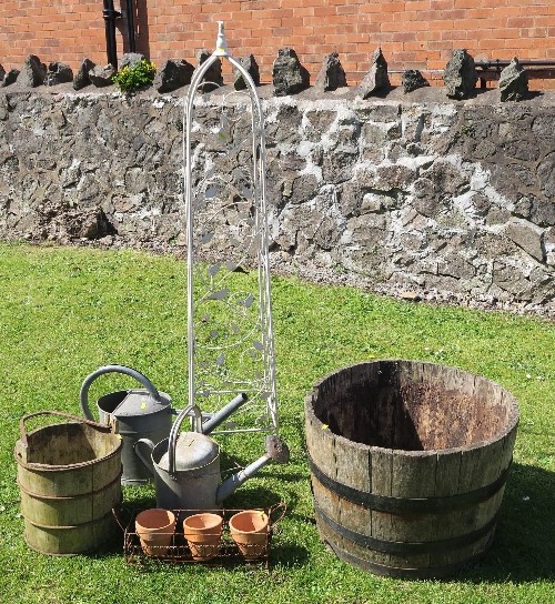 Two watering cans, a metal obelisk, a barrel diameter 25.5ins, and other items