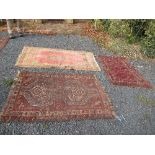 An Eastern design rug, decorated with a central panel of a brown lozenge to a patterned border,