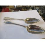 A pair of Georgian silver fiddle pattern serving spoons, engraved with a crest, London 1814,