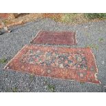 An Eastern design rug, decorated with a central panel of blue, red and cream pattern in a red