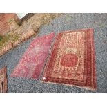 An Eastern design rung, with central medallions to a red ground and patterned border, 56ins x 32ins,