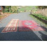 A large Eastern design rug, decorated with a central medallion in a pale blue field, to red ground