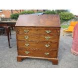 A Georgian mahogany bureau, fitted with four long drawers below the fall flap, opening to reveal