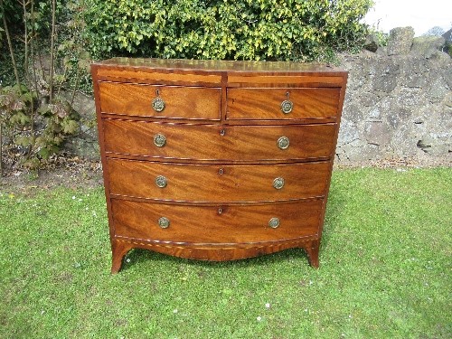 A 19th century mahogany bow fronted chest of drawers, with satinwood cross banding, fitted two short